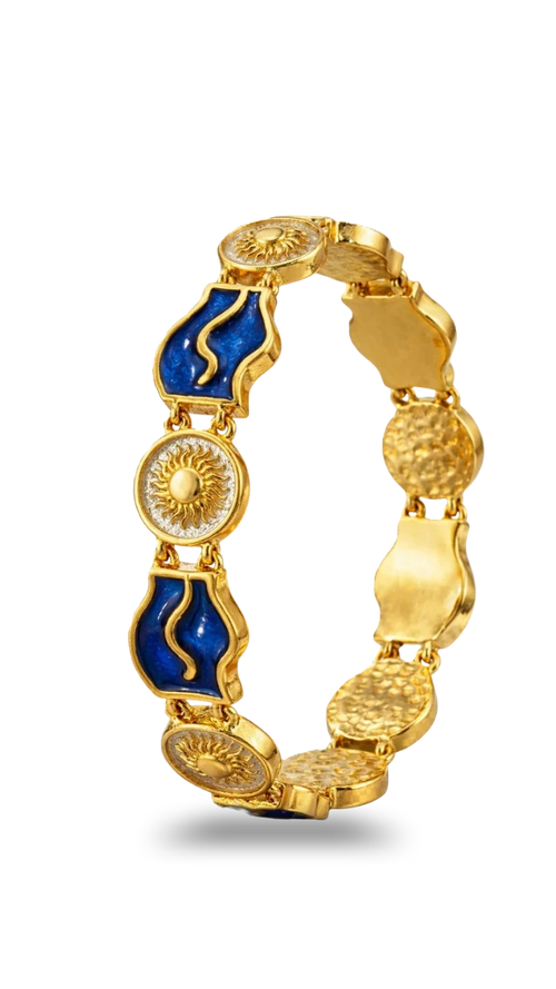 Gold bracelet with blue accents on a white background